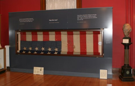 museum display of the lincoln flag with a bust of abraham lincoln