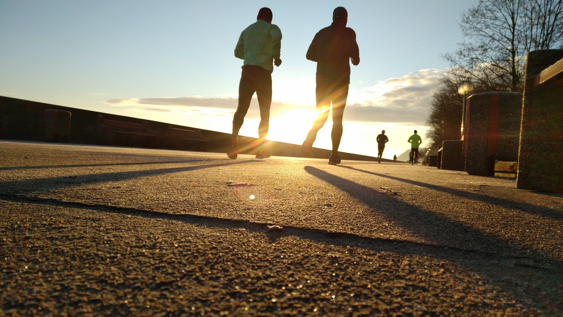 two men running during sun set